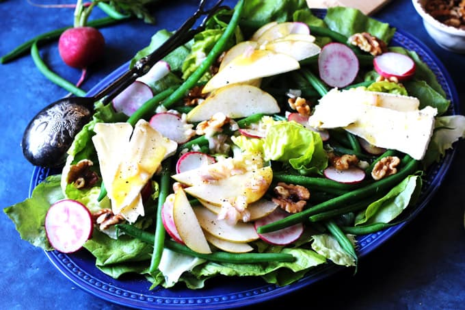French Salad with Brie and Pears is a wonderful option for those nights when you want to eat a salad but you desire a bit more than just a simple Green Salad. This French Salad recipe is perfect when you want to eat low carb meal without sacrificing on taste and nutrition. Butter lettuce, French green beans, radishes, and pears add a healthy dose of vitamins; and walnuts - give you some healthy fats; and finally the brie cheese - will provide you with needed protein. This salad is naturally gluten-free, and oh so delicious! French salad on a blue serving plate