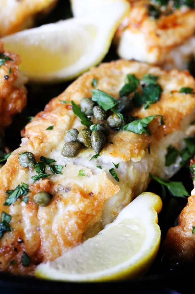 This Pan Fried Cod with Meuniere Sauce comes together in just 15 minutes! No gimmicks...it really is super simple. With just a few steps and your dinner is ready. And it will wow your kitchen patrons. Close up shot with Meniere sauce and capers