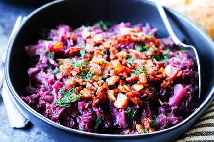 Horizontal shot of red braised cabbage in a bowl with spoon