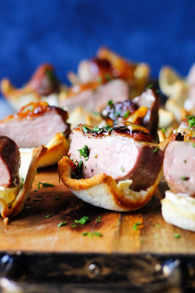 Orange Duck bites with brie on toast