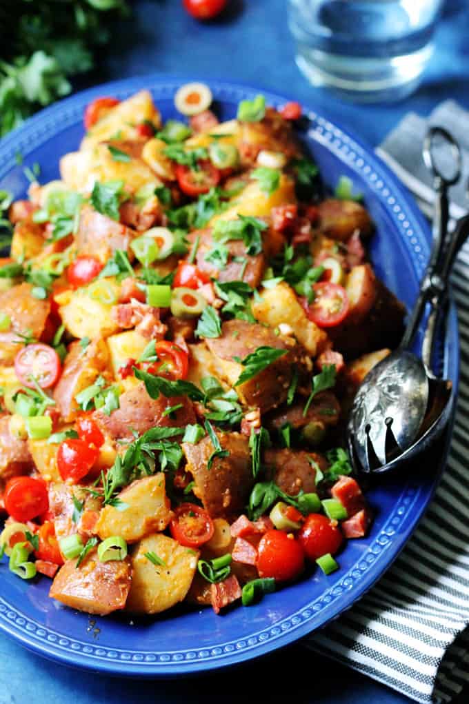 Smoky Spanish Potato Salad with Roasted Peppers and Chorizo on a serving plate