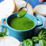 Basil sauce in a blue ramekin with spoon