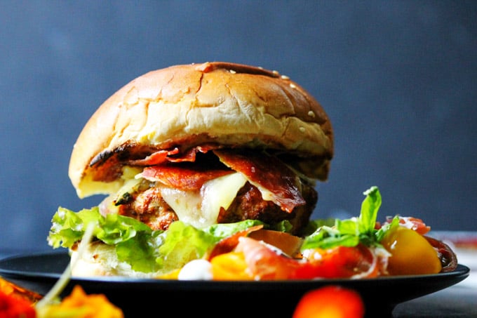 Turkey burger with Bayonne Ham with side salad on a plate