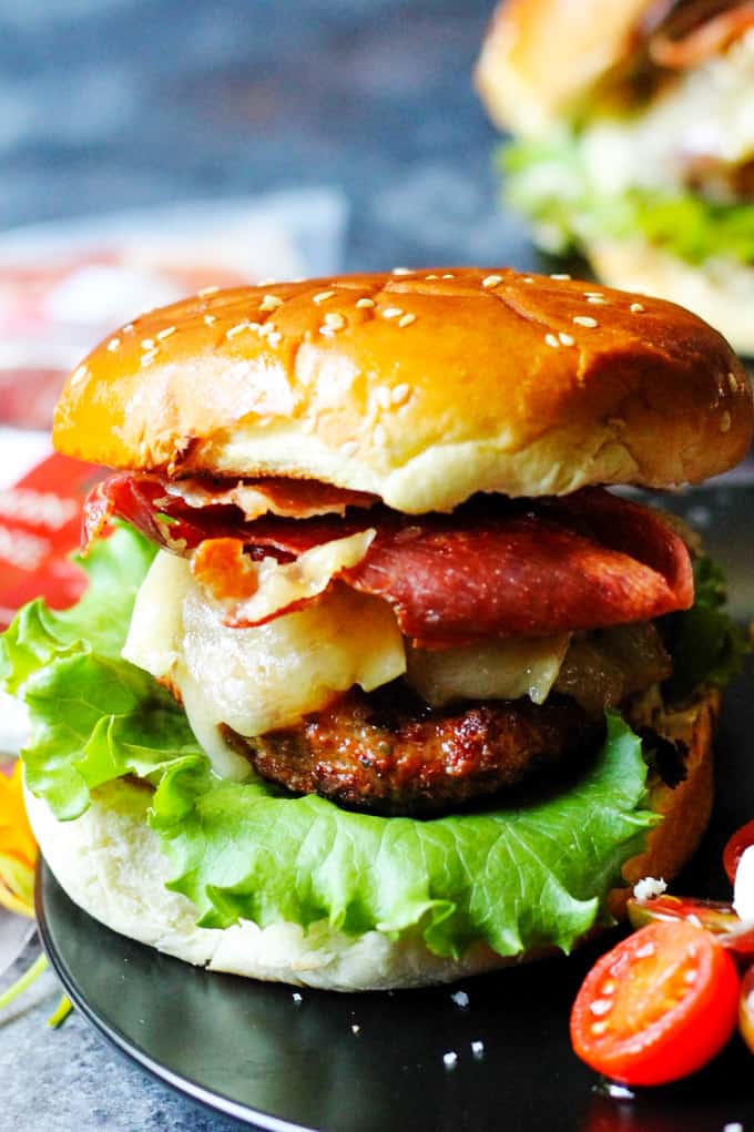 Turkey burger with brie cheese and Bayonne ham on a plate