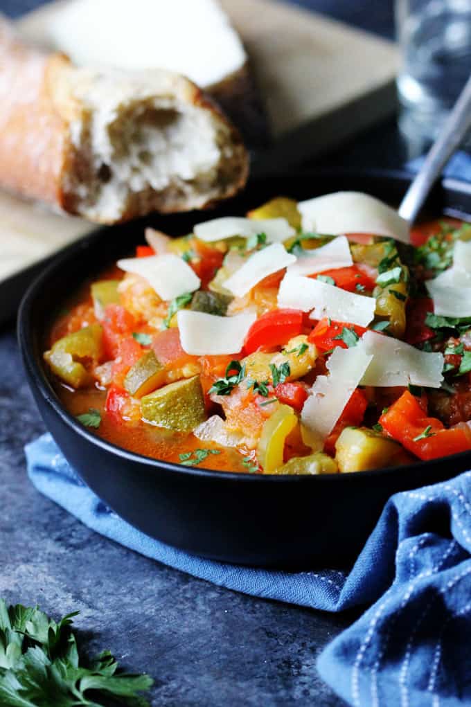 Spanish Ratatouille in a black bowl with spoon 
