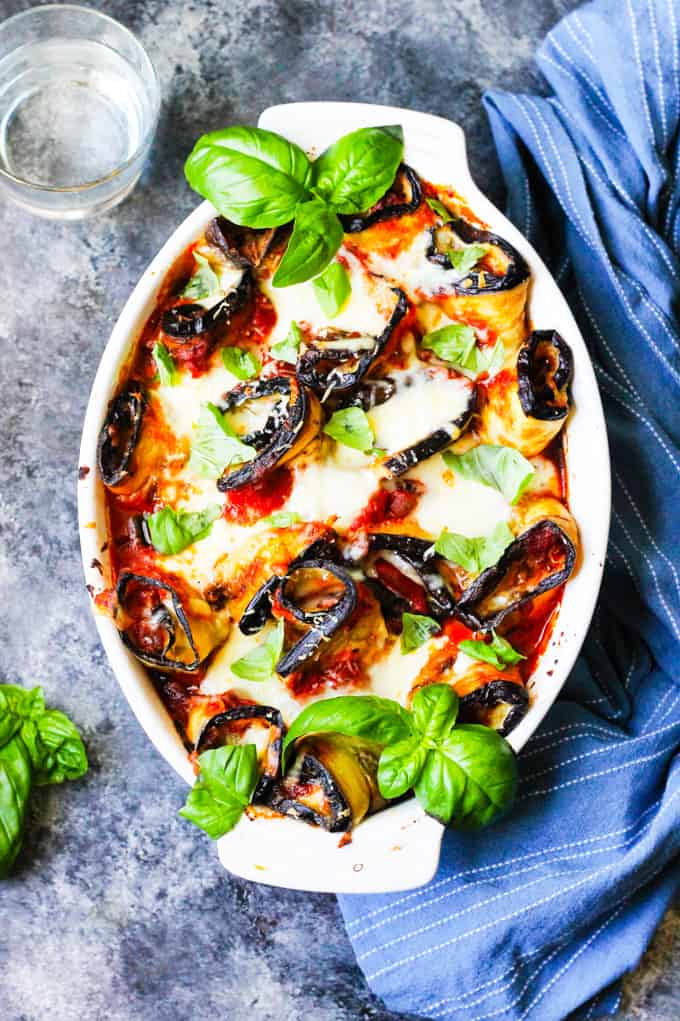 Eggplant Rollatini Parmigiaina in white casserole dish