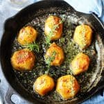 Horizontal Photo of Fondant potatoes in a cast iron sklllet