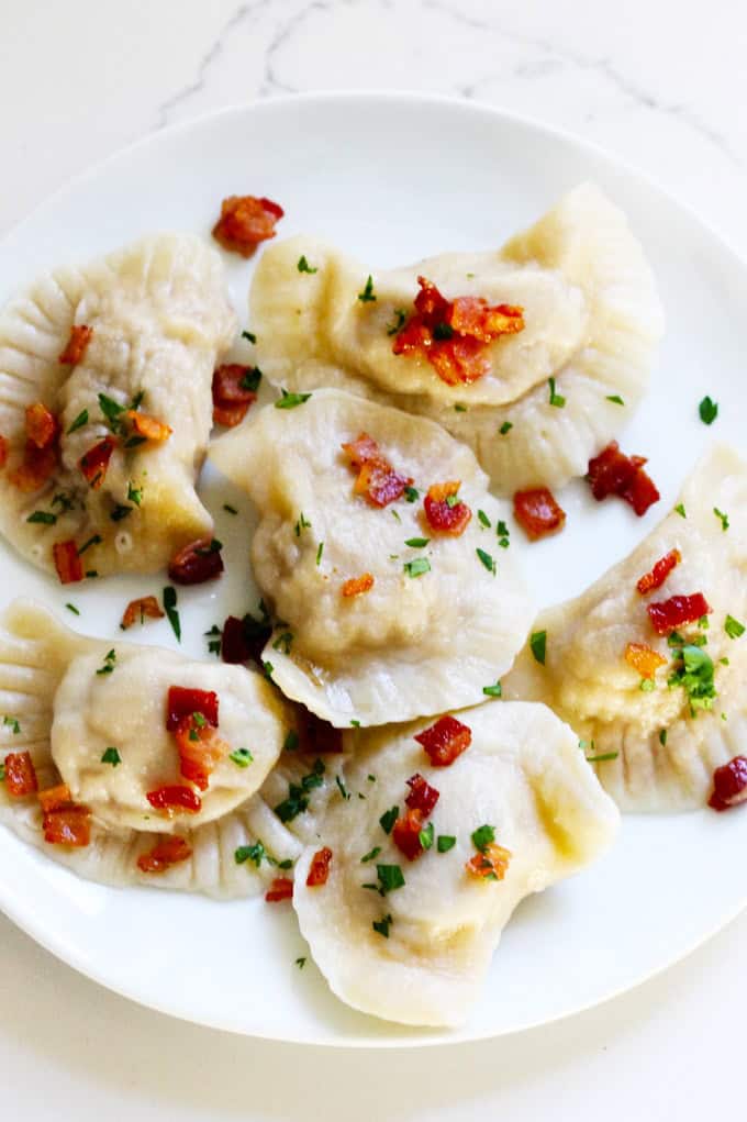 A white plate filled with Polish Meat Pierogi