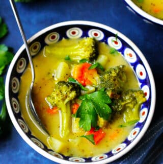 Picture of Broccoli Leek Potato Soup in a blue bowl with a spoon
