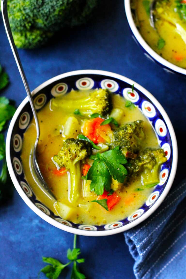 Picture of Broccoli Leek Potato Soup in a blue bowl with a spoon