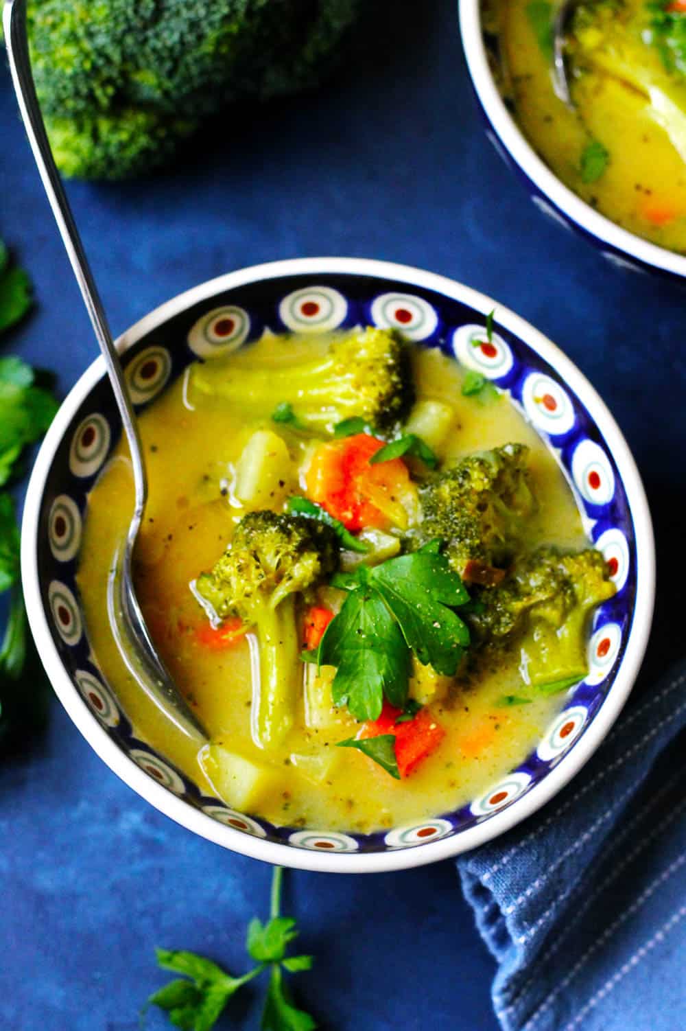 Picture of Broccoli Leek Potato Soup in a blue bowl with a spoon