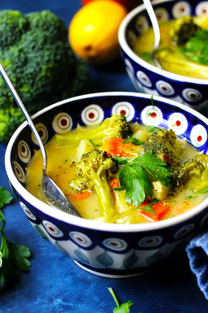 A close up picture of Broccoli Leek Potato Soup in a blue and white bowl