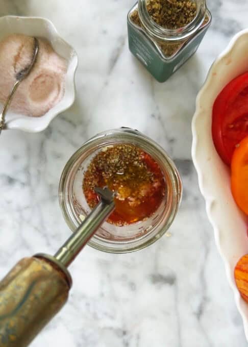 Oregano and red wine vinegar added to the mason jar