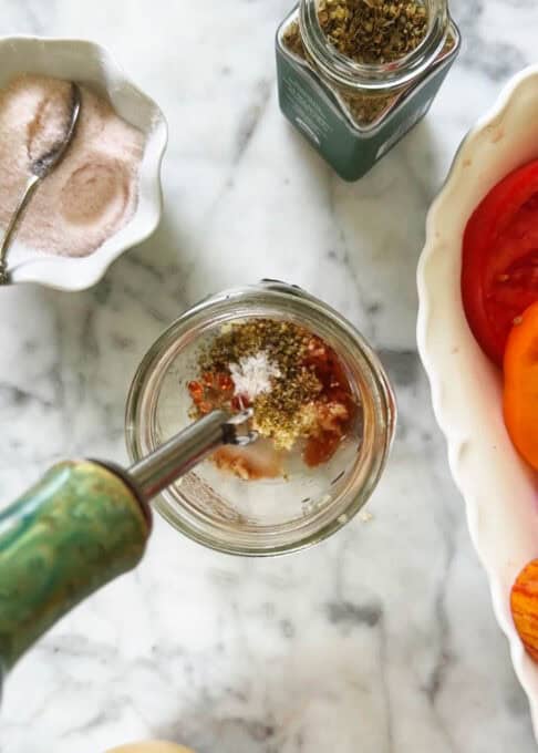 Olive oil being poured into the mason jar