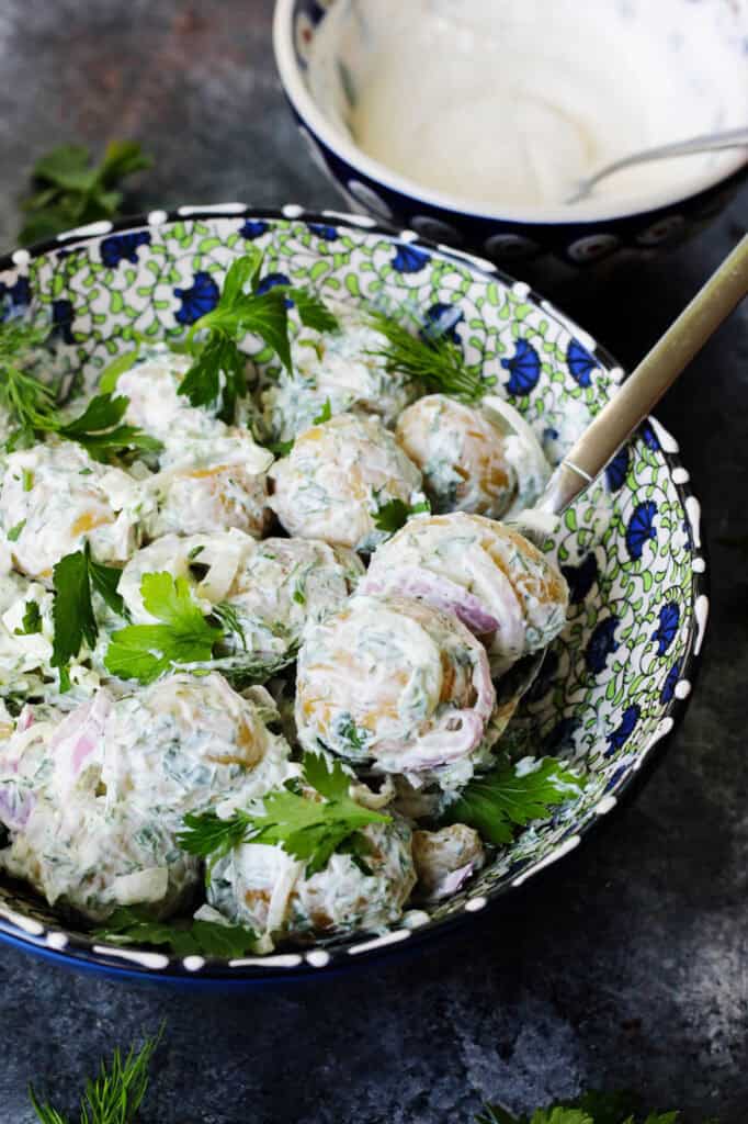 Closeup of baby potato salad with a spoon