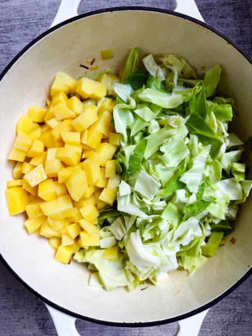Potatoes and cabbage added to the Dutch oven