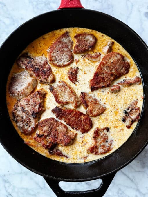 Overhead view of creamy sauce for pork medallions
