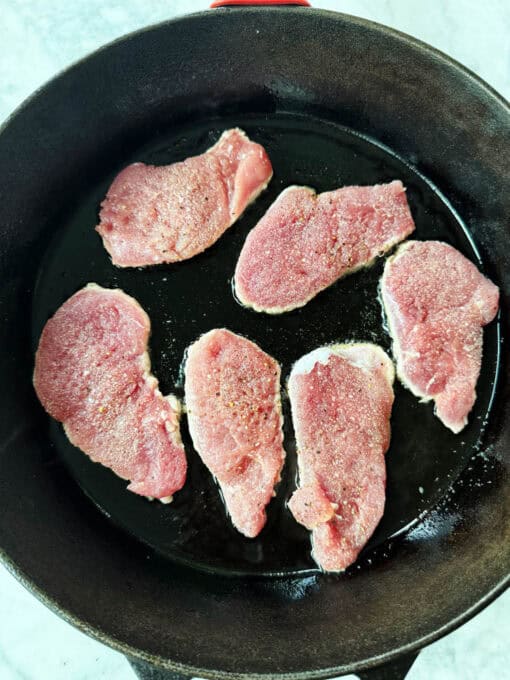 Overhead of pork medallions in a skillet