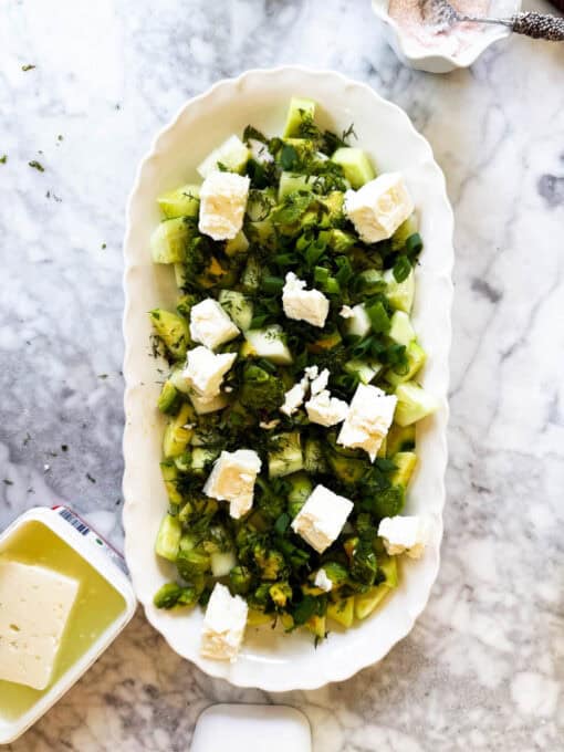Chunks of feta are added to the salad