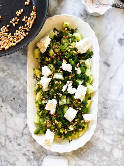 Toasted pine nuts added to the salad