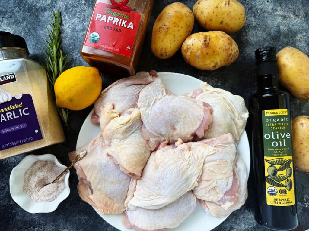 Ingredients for roast chicken thighs and potatoes on a table