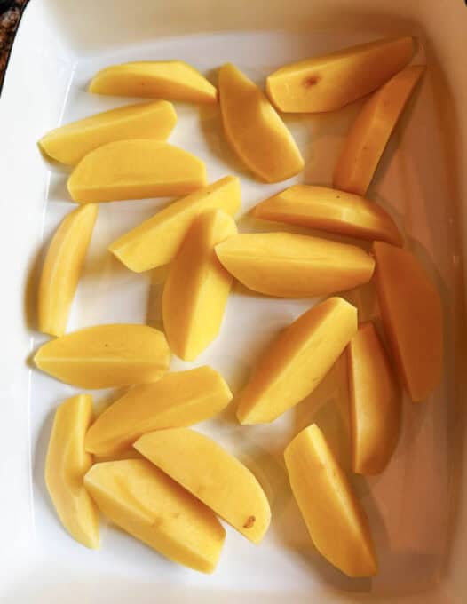 Potatoes at the bottom of an oven dish