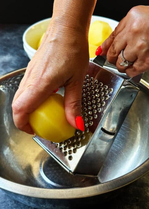 Grating a potato on the fine side of the grater