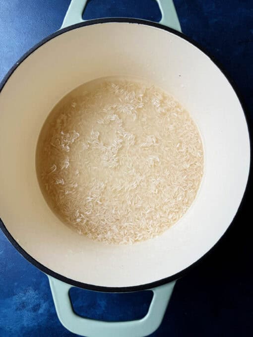 Rice and water cooking in a pot