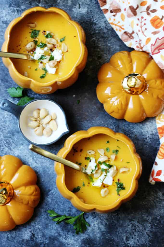 Overhead of bowls of simple roasted butternut squash soup