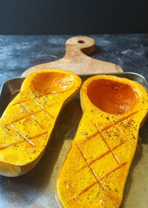 Prepared butternut squash on a baking sheet