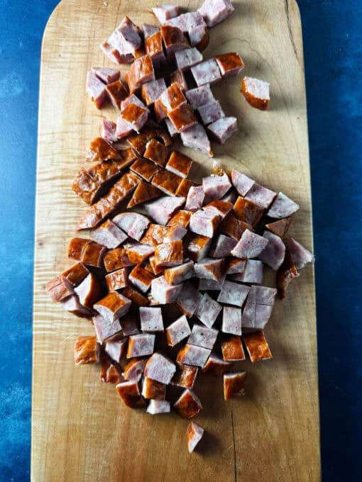 Cubed kielbasa on a cutting board