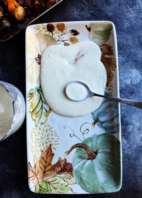 Whipped feta being spread on a plate